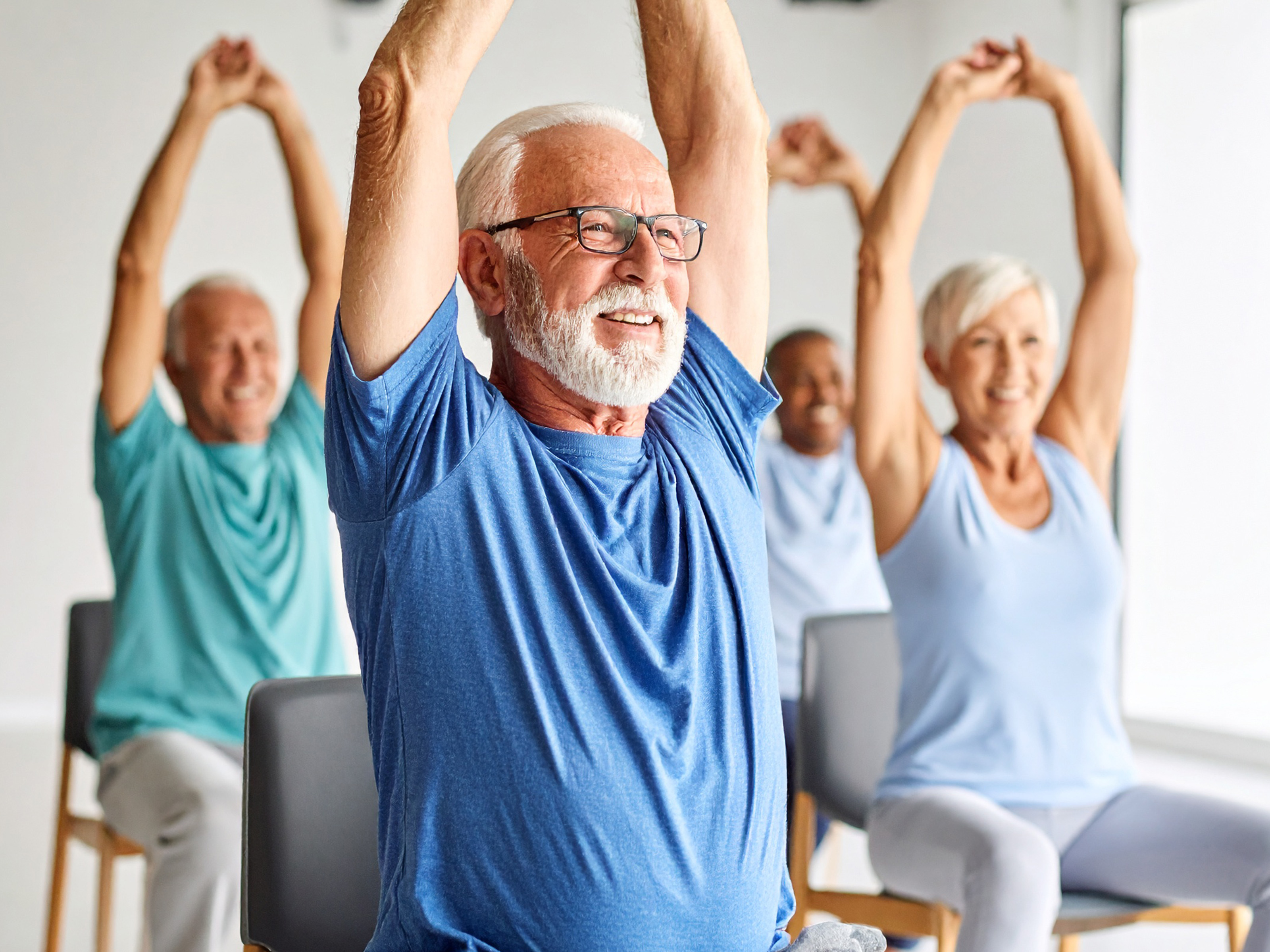 Group of senior people in a chair stretch class