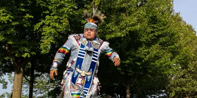 Indigenous dancer in traditional clothing dancing 