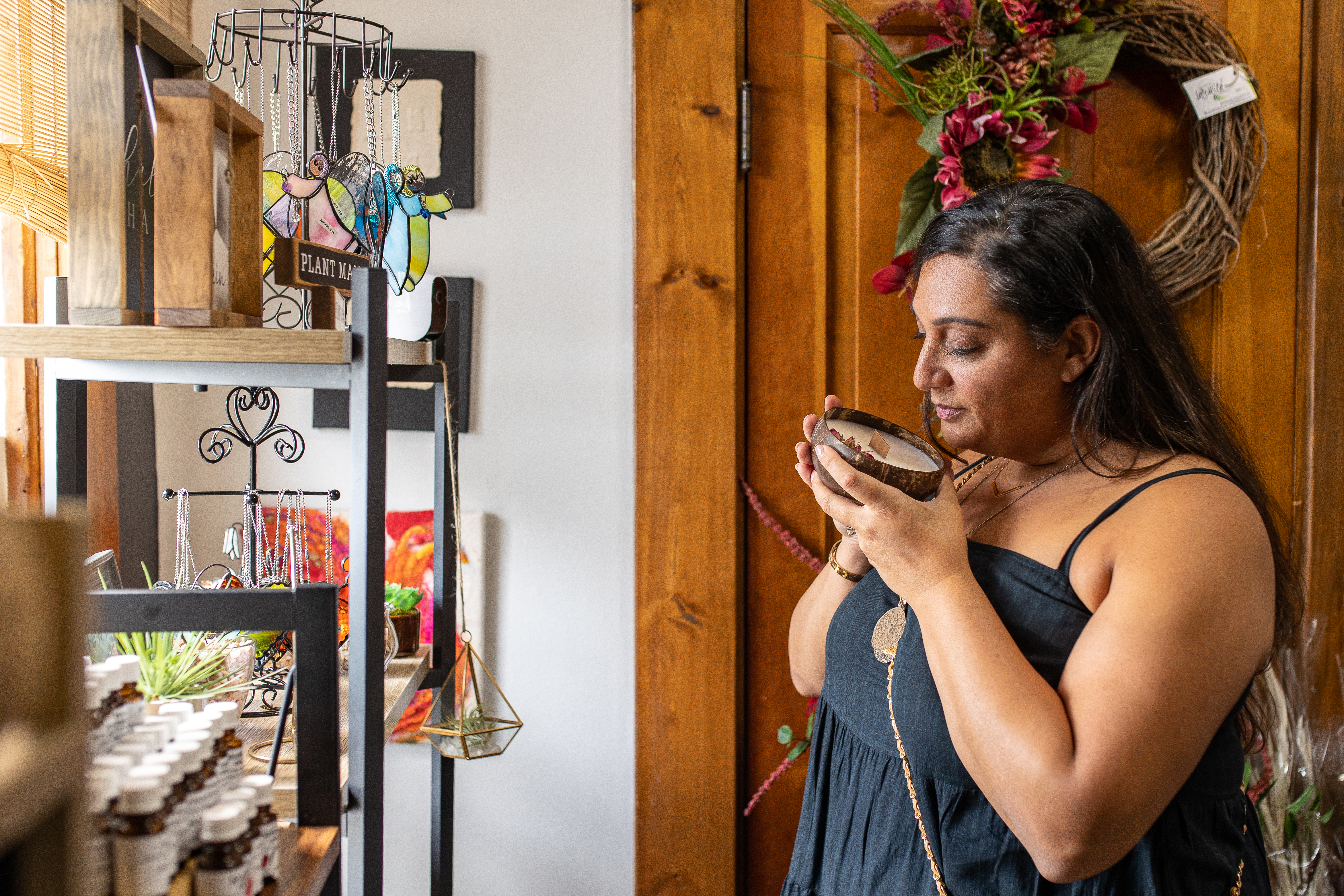 Woman smelling candle and smiling