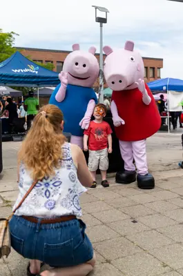 Child posing with Peppa Pig and George 