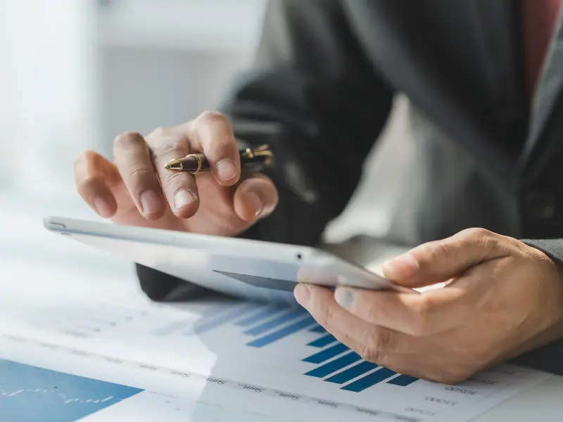 Close up of a person reviewing financial records